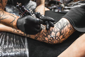 The Reasons Why Tattoo Artists Wear Black Gloves