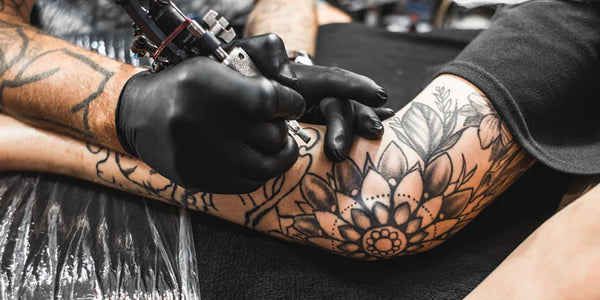 The Reasons Why Tattoo Artists Wear Black Gloves